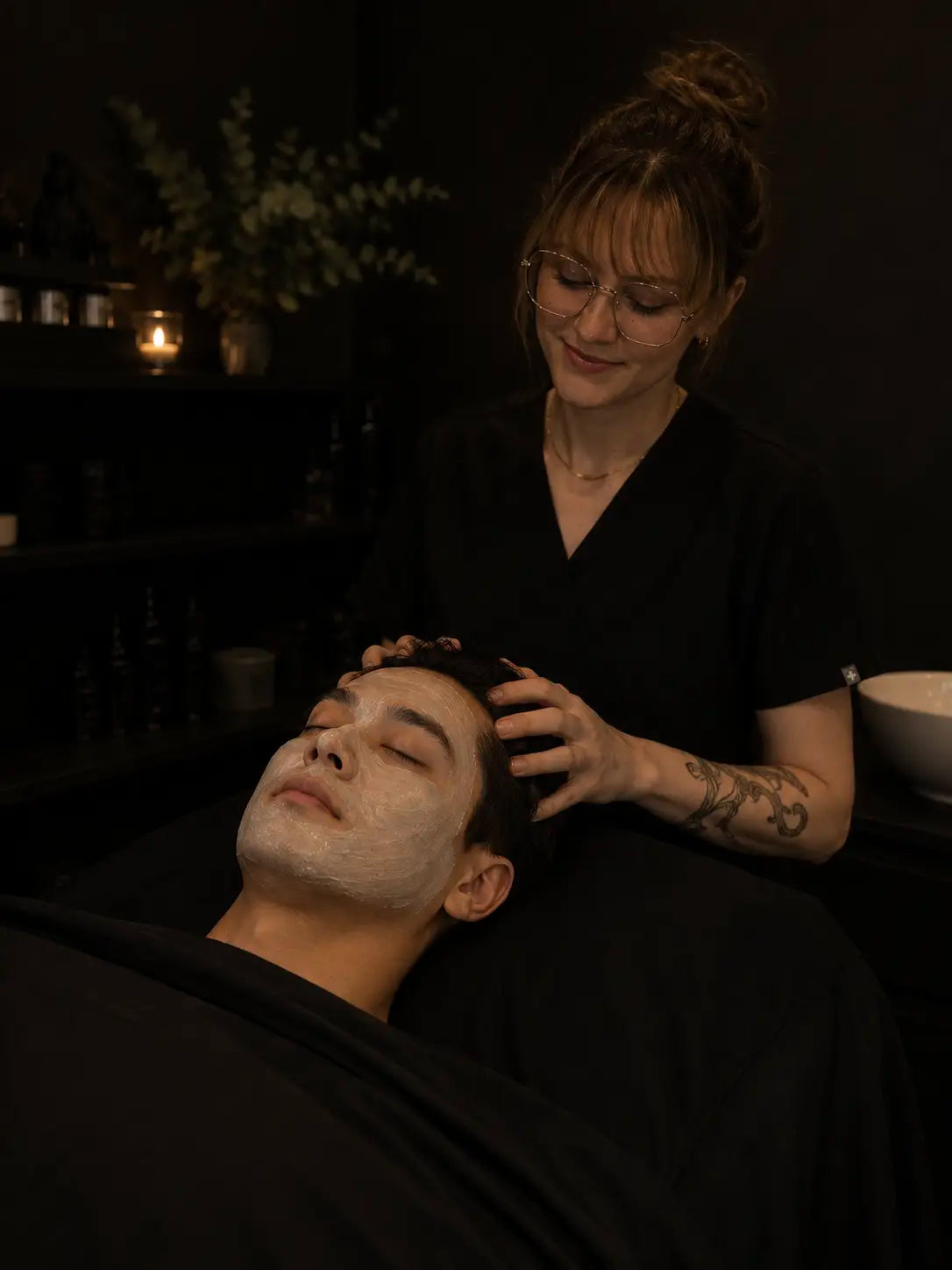 Client receiving a scalp massage during a facial
