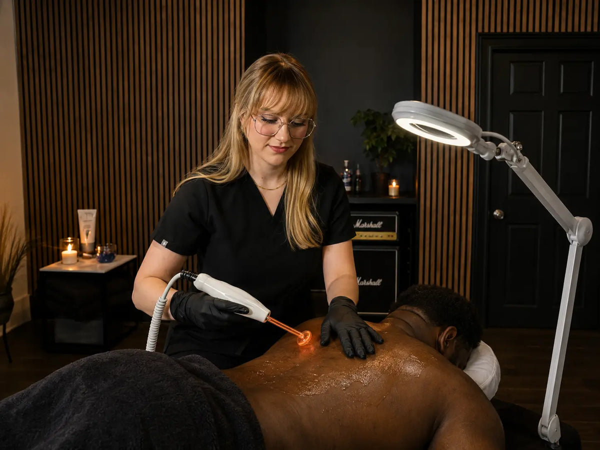 Esthetician doing a high frequency treatment during a back facial