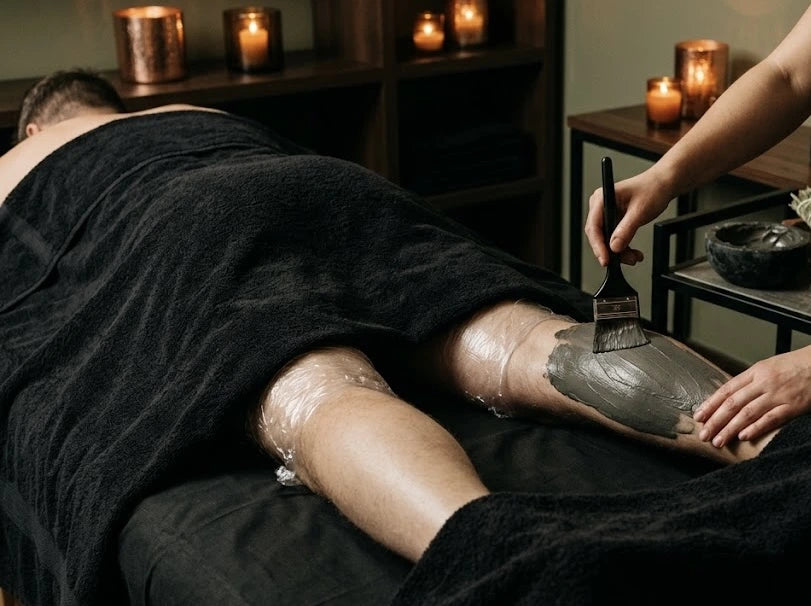 Esthetician at Menscape applying a mask during a Signature body scrub