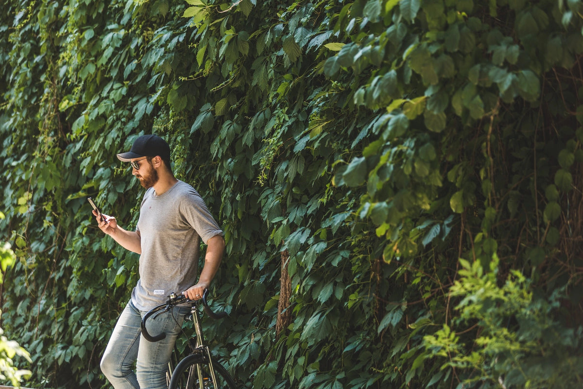 Menscape nashville client outside on phone with bike